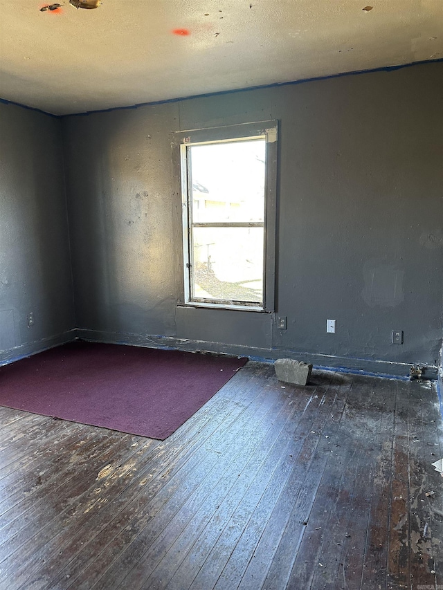 empty room with hardwood / wood-style flooring