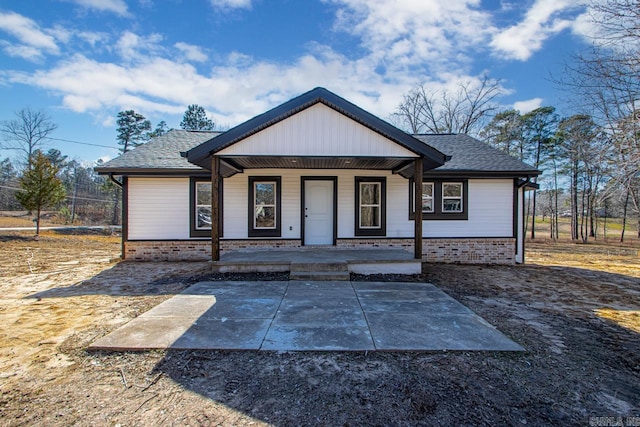 view of front of property featuring a porch and a shingled roof