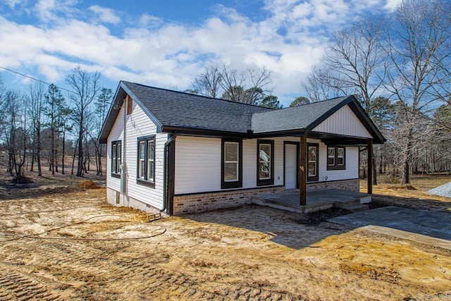 view of front facade with a porch and a shingled roof