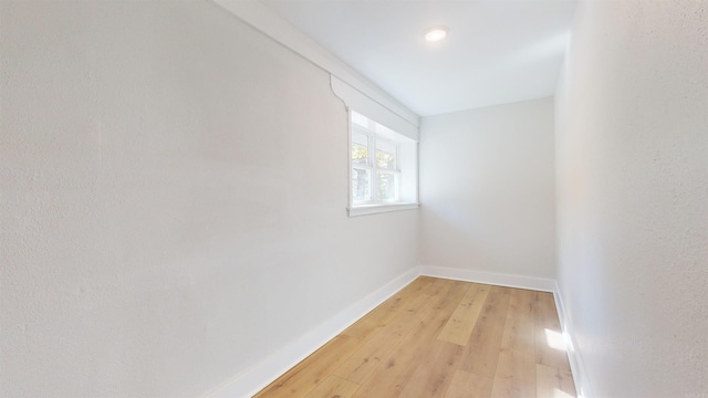 unfurnished room featuring light wood-style flooring and baseboards