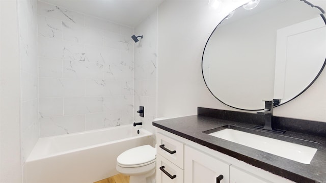 bathroom featuring bathtub / shower combination, vanity, and toilet