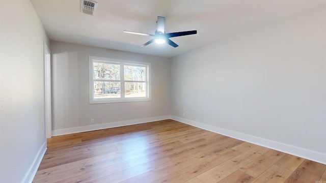 unfurnished room featuring light wood-type flooring, baseboards, visible vents, and ceiling fan