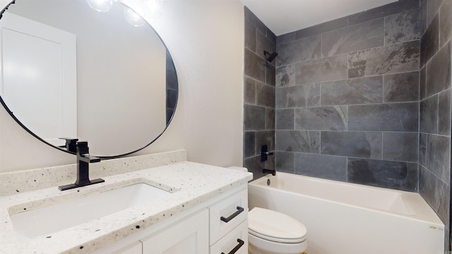 bathroom with washtub / shower combination, vanity, and toilet