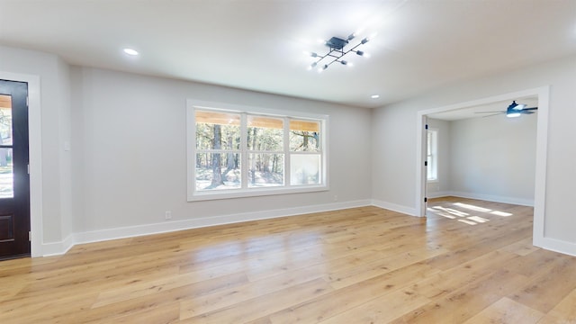 foyer entrance featuring baseboards, recessed lighting, and light wood-style floors