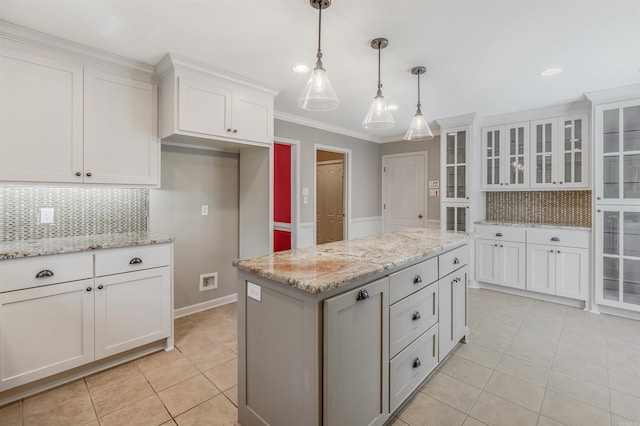 kitchen with decorative light fixtures, light tile patterned flooring, glass insert cabinets, and white cabinets