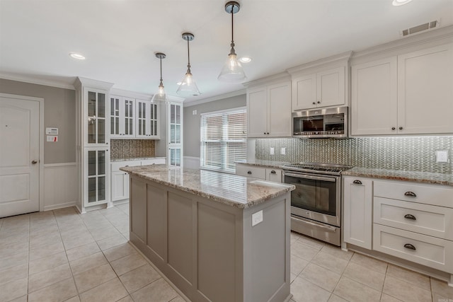 kitchen featuring visible vents, appliances with stainless steel finishes, ornamental molding, light tile patterned flooring, and white cabinetry