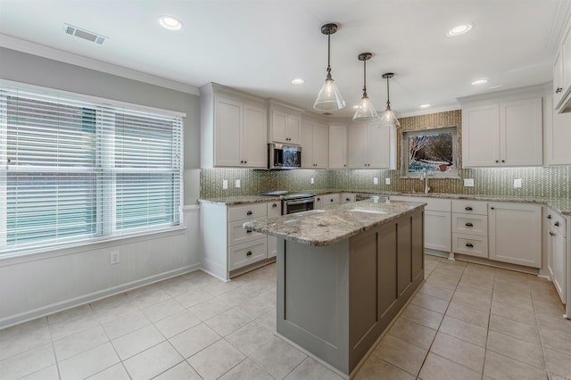 kitchen with tasteful backsplash, visible vents, appliances with stainless steel finishes, crown molding, and light tile patterned flooring