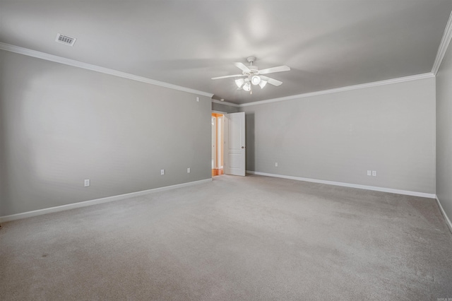 spare room featuring crown molding, visible vents, and baseboards