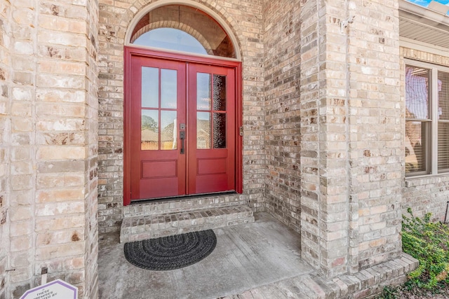 doorway to property with brick siding