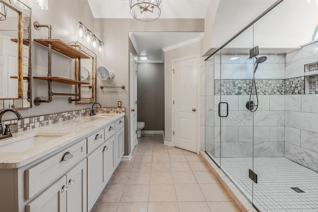 bathroom featuring a stall shower, a sink, toilet, and tile patterned floors