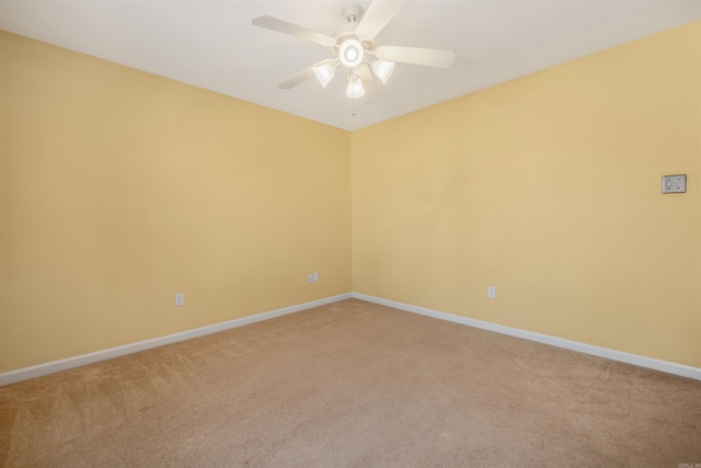 unfurnished room with ceiling fan, baseboards, and light colored carpet