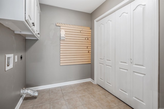 washroom featuring light tile patterned floors, washer hookup, baseboards, cabinet space, and electric dryer hookup