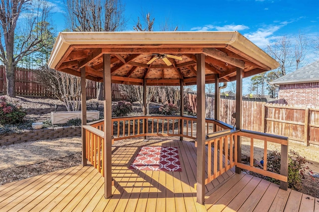 wooden terrace featuring a fenced backyard and a gazebo