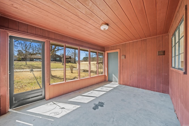 unfurnished sunroom featuring wood ceiling