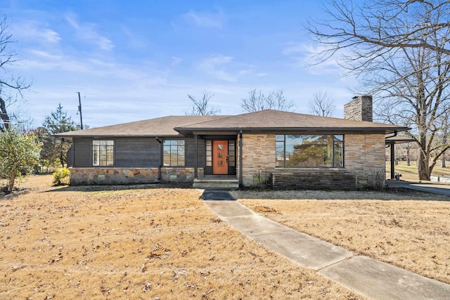 view of front of home featuring stone siding and a chimney