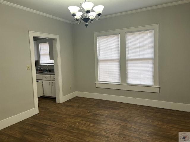 unfurnished dining area featuring a notable chandelier, a sink, baseboards, ornamental molding, and dark wood-style floors