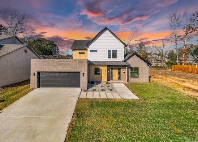 view of front of property with an attached garage, a front lawn, and concrete driveway