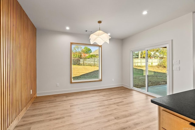 unfurnished dining area featuring light wood-type flooring, baseboards, and recessed lighting