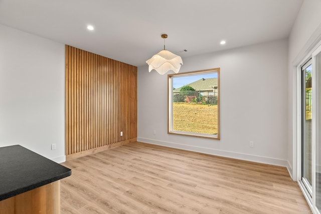 unfurnished dining area with light wood-type flooring, visible vents, baseboards, and recessed lighting