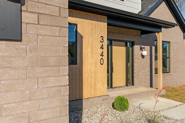 property entrance with brick siding