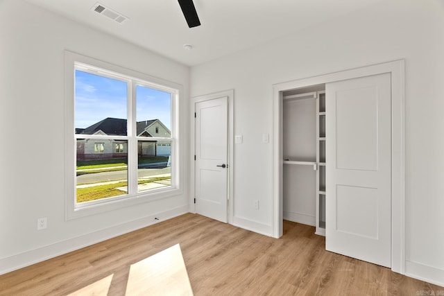 unfurnished bedroom with light wood-type flooring, baseboards, and visible vents