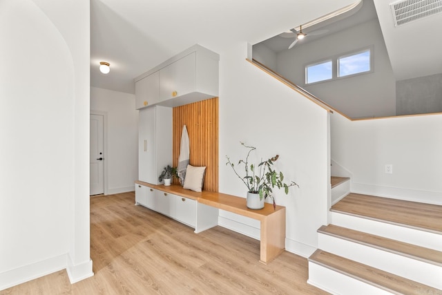 mudroom with light wood-style flooring, visible vents, and baseboards