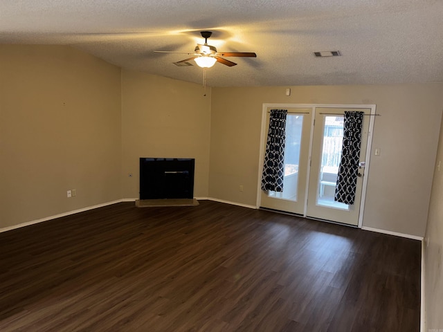 unfurnished living room featuring vaulted ceiling, ceiling fan, dark wood-type flooring, and baseboards