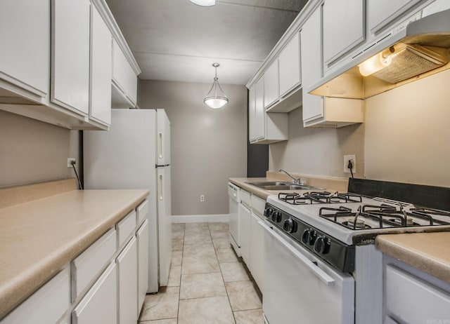 kitchen with custom exhaust hood, white cabinets, a sink, light tile patterned flooring, and white appliances