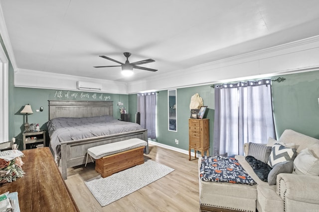 bedroom featuring ornamental molding, wood finished floors, ceiling fan, and a wall mounted AC