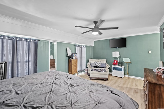 bedroom featuring baseboards, ornamental molding, and wood finished floors