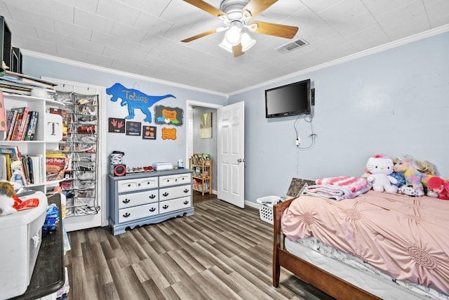 bedroom featuring ornamental molding, visible vents, ceiling fan, and wood finished floors