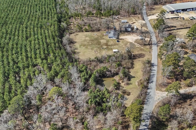 drone / aerial view featuring a wooded view