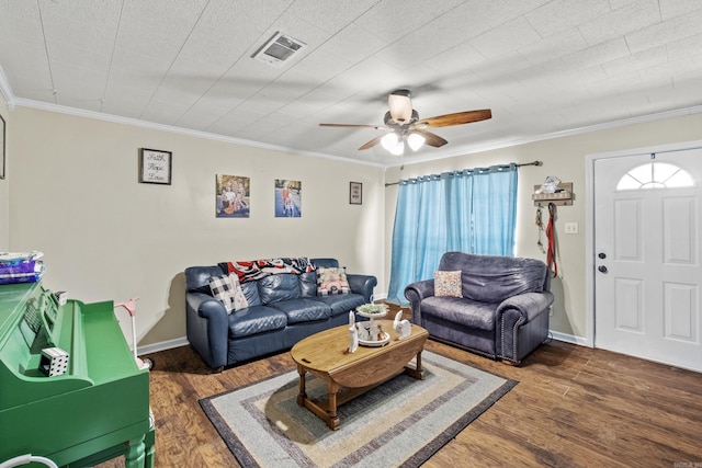 living area featuring ornamental molding, visible vents, and wood finished floors