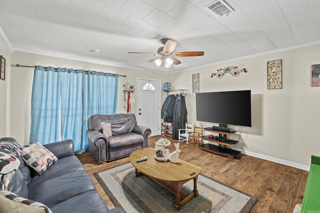 living room featuring wood finished floors, visible vents, and crown molding