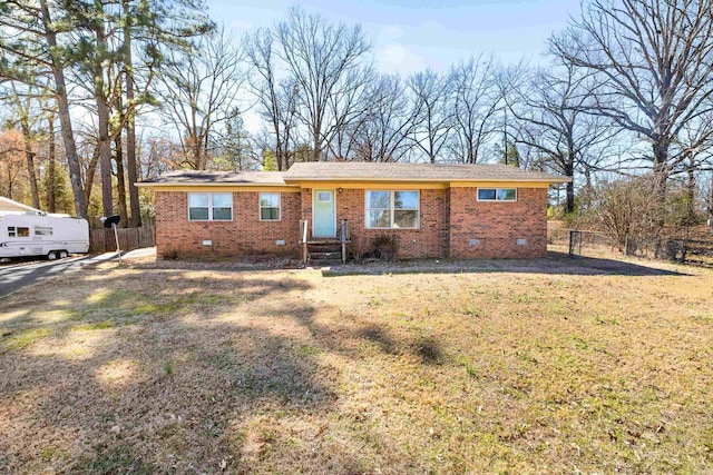 single story home featuring brick siding, crawl space, a front yard, and fence