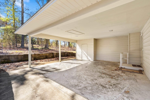 view of patio with a carport and fence