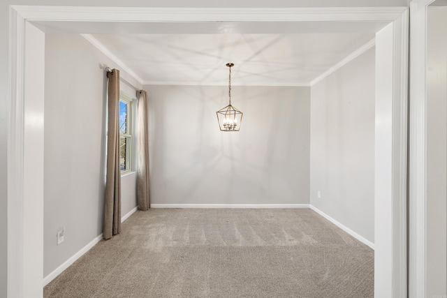 spare room with a notable chandelier, baseboards, ornamental molding, and carpet flooring