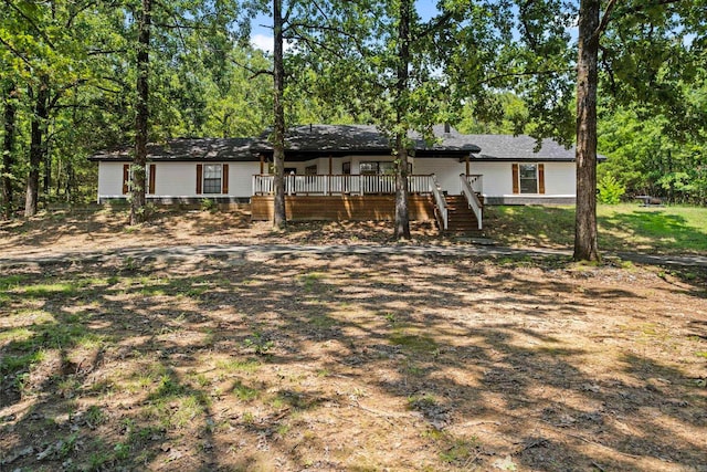 view of front of property with stairway and a deck