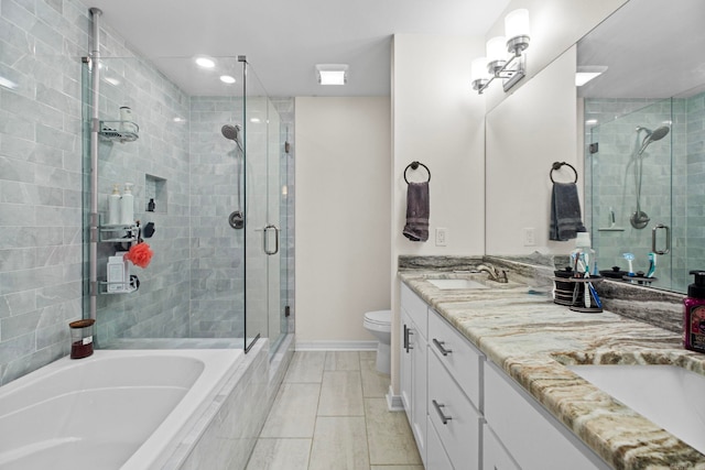 bathroom with toilet, a sink, a shower stall, a bath, and double vanity