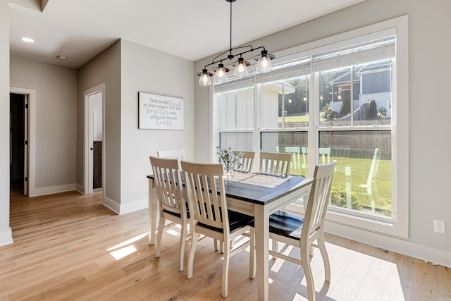 dining room featuring light wood-type flooring and baseboards