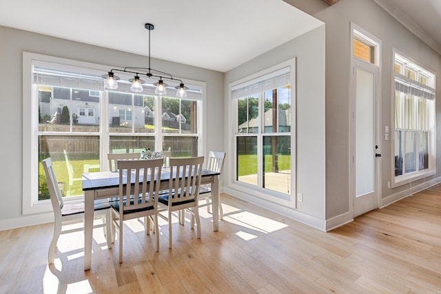 dining space featuring wood finished floors and baseboards