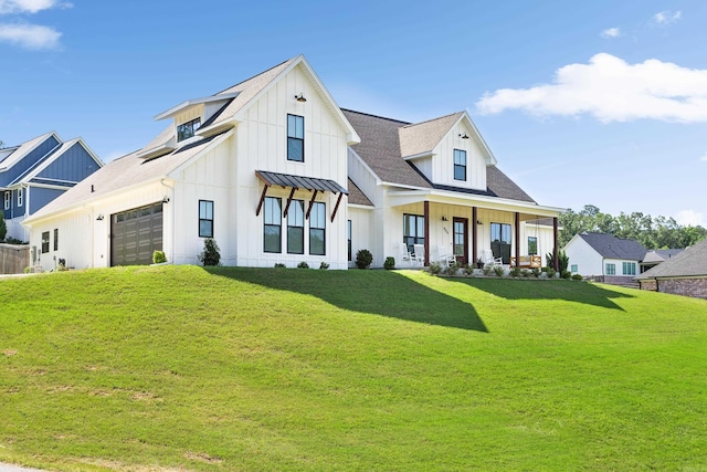 modern farmhouse style home with a garage, covered porch, a shingled roof, board and batten siding, and a front yard