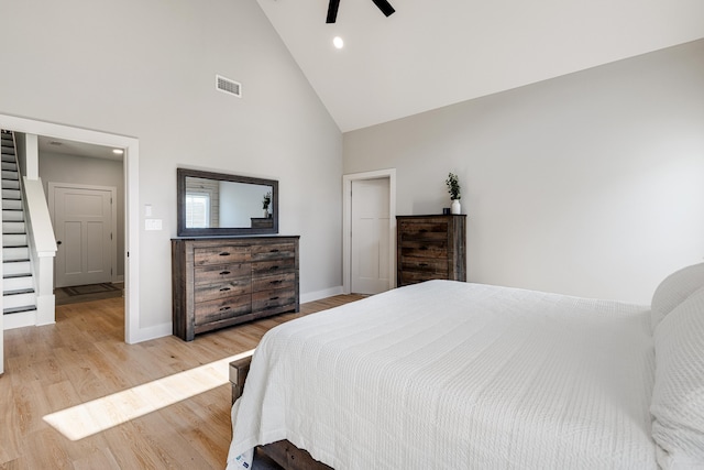 bedroom featuring visible vents, ceiling fan, high vaulted ceiling, light wood-type flooring, and baseboards