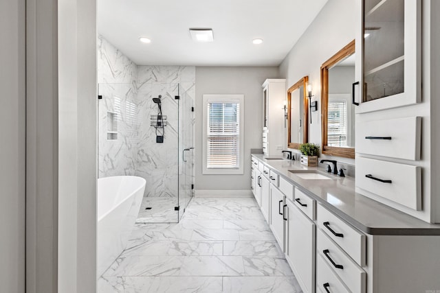 full bathroom featuring a freestanding tub, marble finish floor, a sink, and a marble finish shower