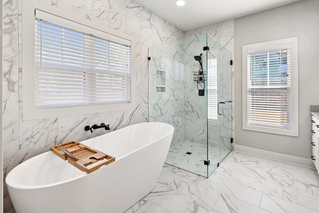 full bath with marble finish floor, a freestanding tub, a marble finish shower, and recessed lighting