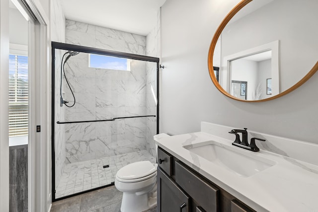 full bath featuring toilet, a marble finish shower, and vanity