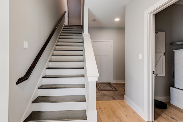 stairs featuring recessed lighting, visible vents, baseboards, and wood finished floors