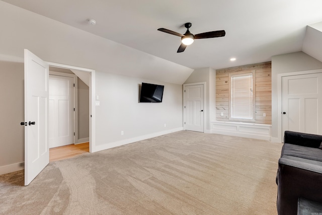 additional living space with lofted ceiling, recessed lighting, light colored carpet, ceiling fan, and baseboards