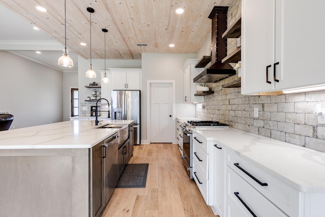 kitchen with open shelves, hanging light fixtures, decorative backsplash, appliances with stainless steel finishes, and light wood-type flooring