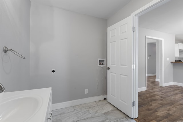 bathroom with baseboards and a sink